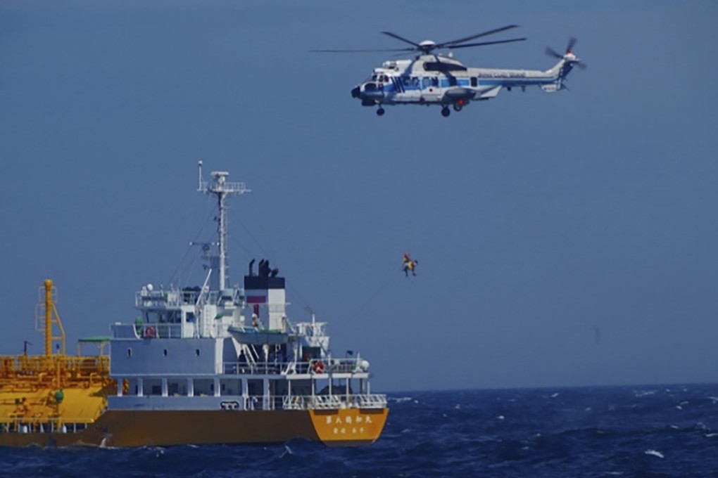 A woman is airlifted by a coastguard helicopter off Nojimazaki, Chiba prefecture, in Japan on Wednesday. Photo: Japan Coast Guard via AP
