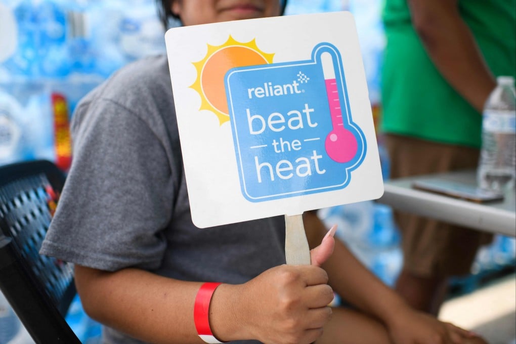 A woman holds up a fan in Houston, Texas. Many are still grappling with power outages and facing the looming dangers of intense heat and humidity following Hurricane Beryl. Photo: AFP