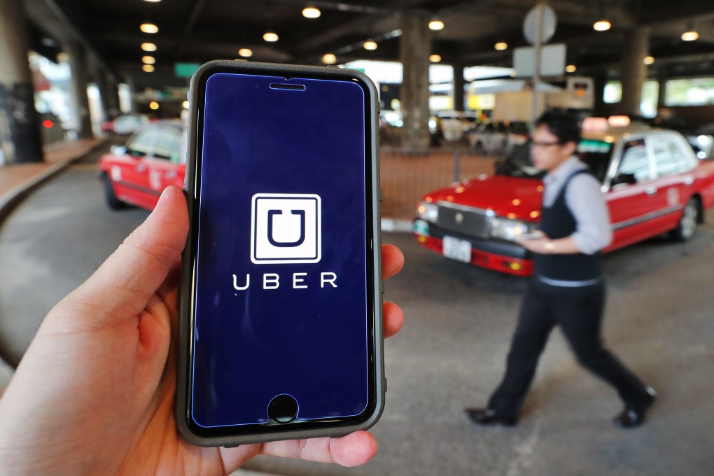 A traveller uses the Uber app on his mobile telephone in Admiralty. Hong Kong’s government has revealed proposals for regulating ride-hailing services that are aimed at clarifying the status of Uber and other such services. Photo: Winson Wong