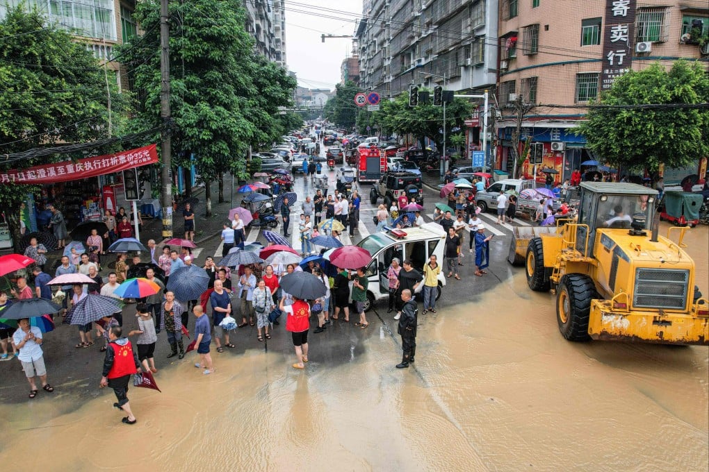 Residents of Chongqing’s Dianjiang county are evacuated from a flooded area on Thursday. Photo: AFP