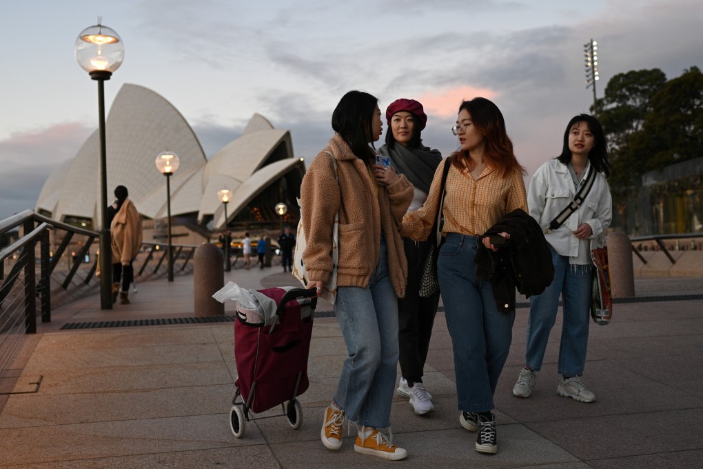 International students walk by Sydney Opera House. Analysts warn Australia risks falling behind if it continues to rely on English alone. Photo: Reuters