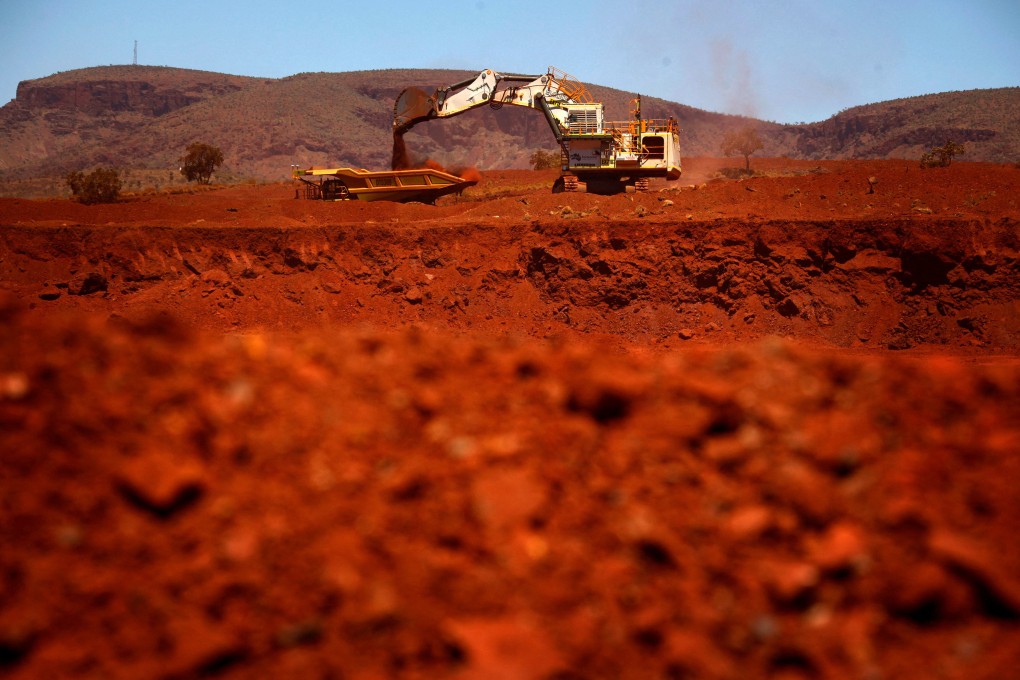 An excavator loads iron ore into a truck at a mine in the Pilbara region of Western Australia. Photo: Reuters