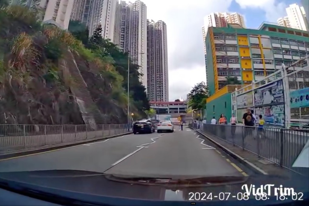 Screengrab of dashcam footage showing a white car speeding past a school marshal. Photo: Facebook/Chi Hong Cheung