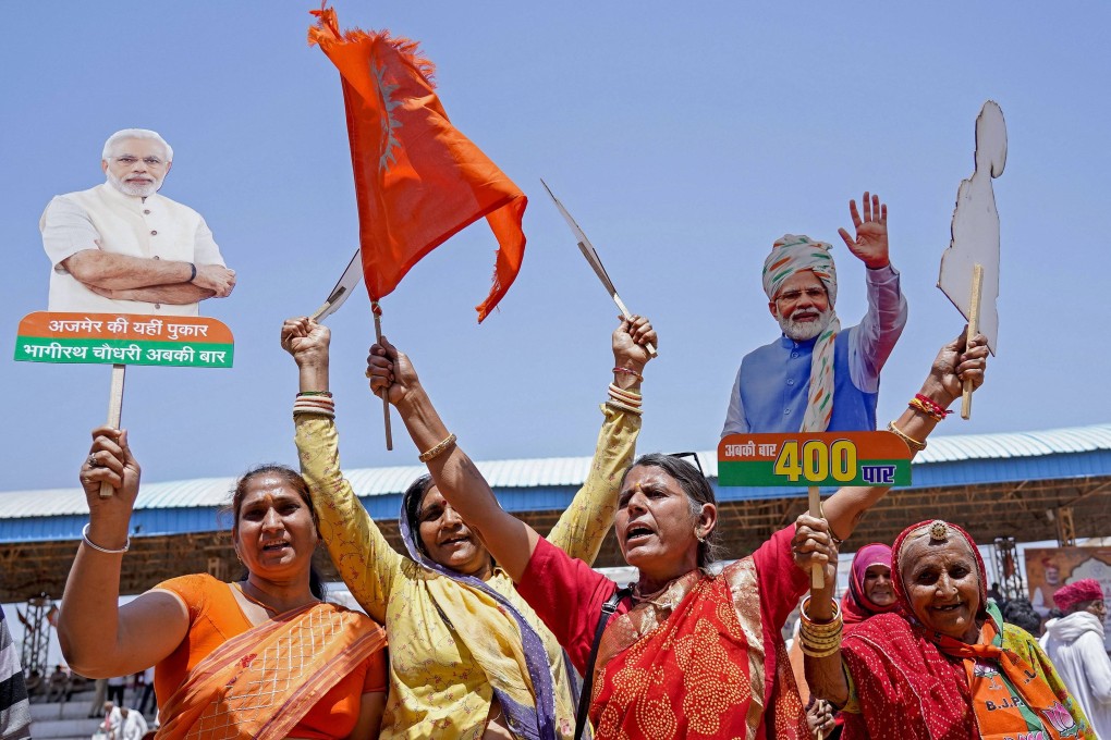 Supporters carrying cutouts of India’s Prime Minister Narendra Modi at an election campaign rally in Pushkar. Photo: AFP