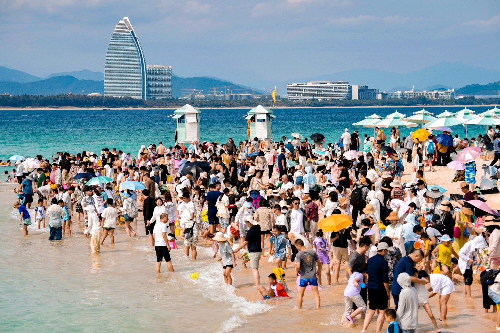 Tourists take to the beach on mainland China’s island province of Hainan. Photo: Xinhua