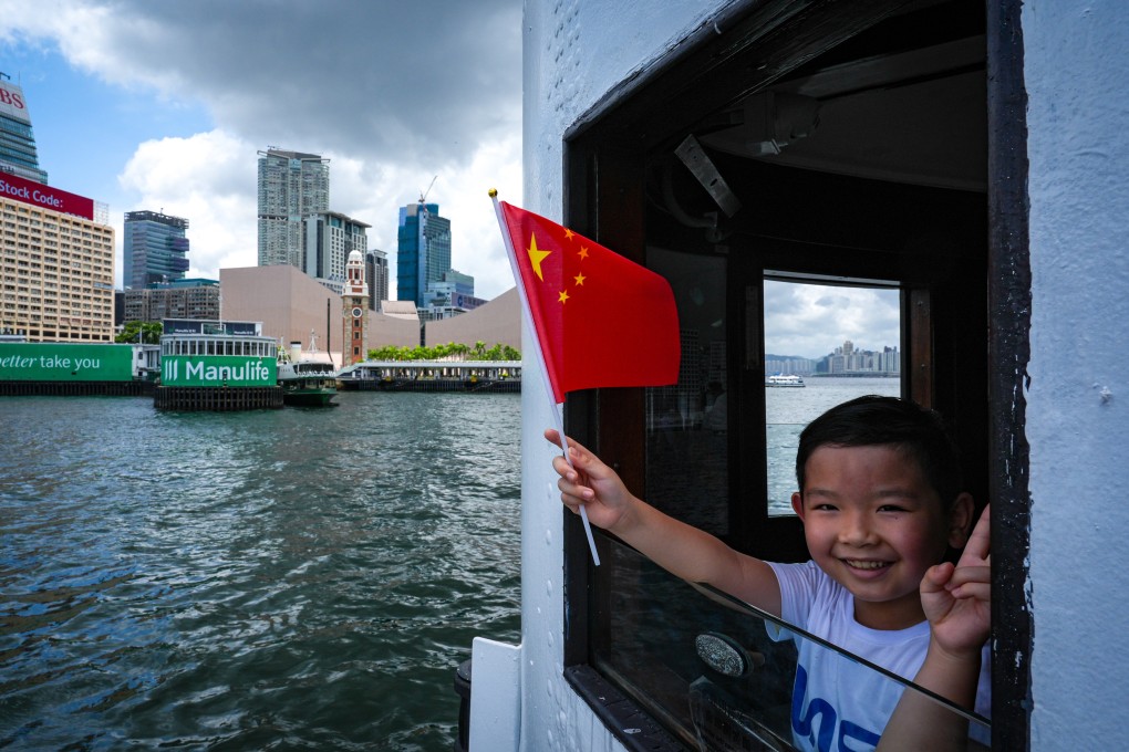 A child waves a mainland Chinese flag while on a ferry from Wan Chai to Tsim Sha Tsui. Photo: Eugene Lee