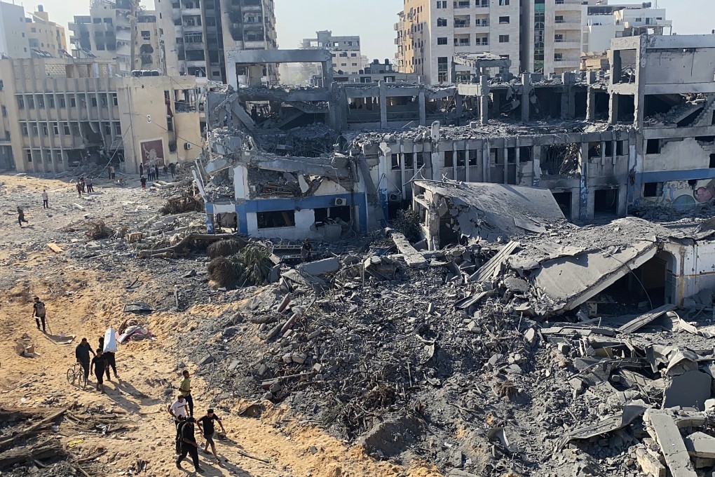 Palestinians inspect the damaged UNRWA building complex in western Gaza City’s Al-Sinaa neighbourhood on July 12. Photo: APA Images via ZUMA Press Wire/dpa