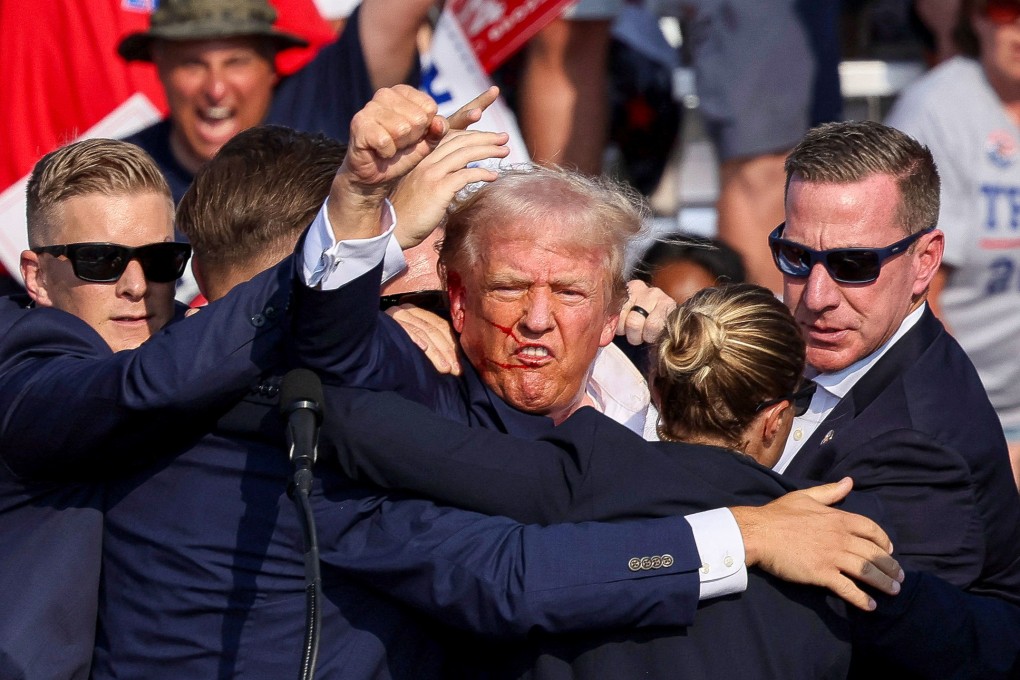 Republican presidential candidate and former US president Donald Trump is assisted by security personnel after gunfire rang out during a campaign rally in Pennsylvania on Saturday. Photo: Reuters