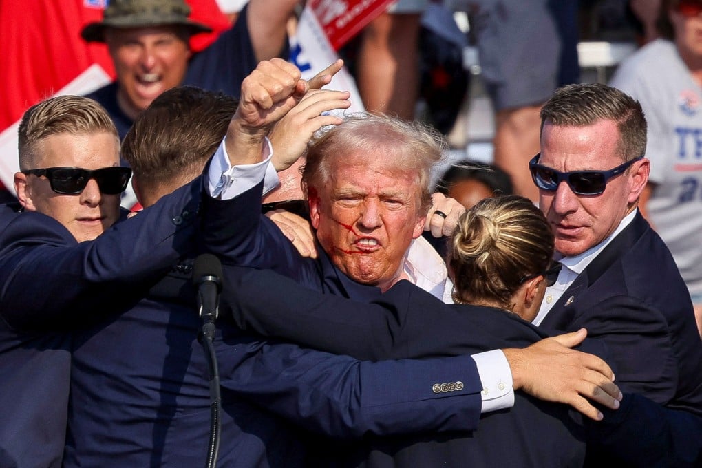 Republican presidential candidate and former US president Donald Trump is assisted by security personnel after gunfire rang out during a campaign rally in Pennsylvania on Saturday. Photo: Reuters