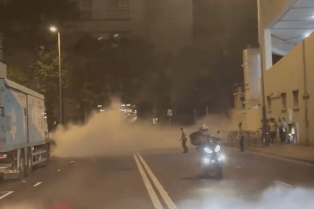 A motorcyclist was seen driving through the smoke in the clip, while two security guards tried to direct traffic as pedestrians looked on. Photo: Facebook/Jason Ka