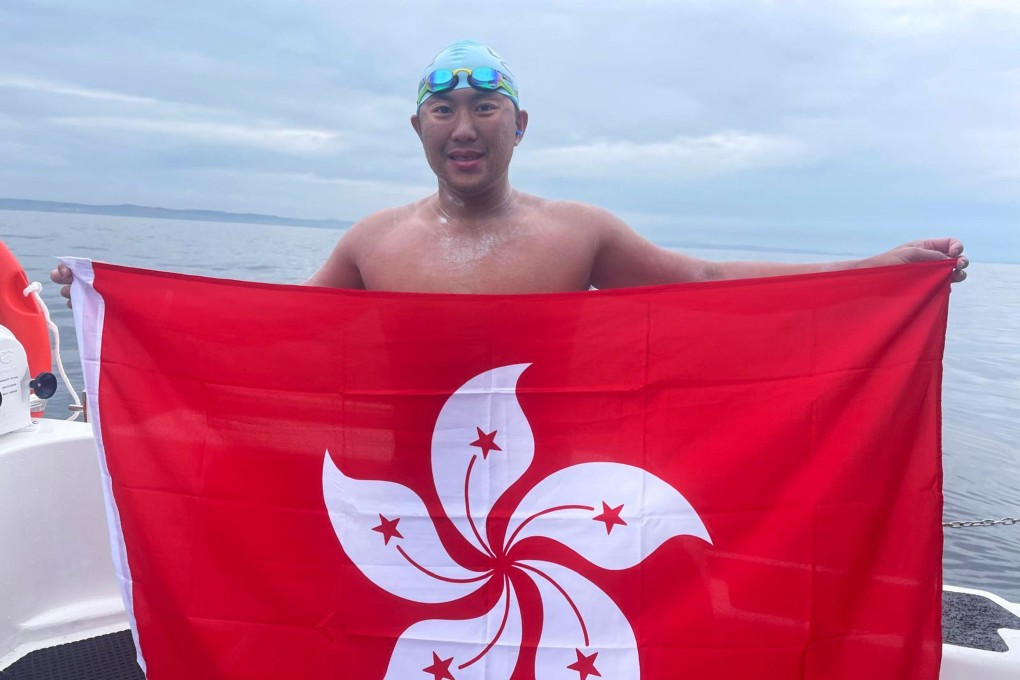 Ryan Leung holds up the Hong Kong flag in Portpatrick on the west coast of Scotland after completing a gruelling 40km swim from Northern Ireland. Photo: Handout