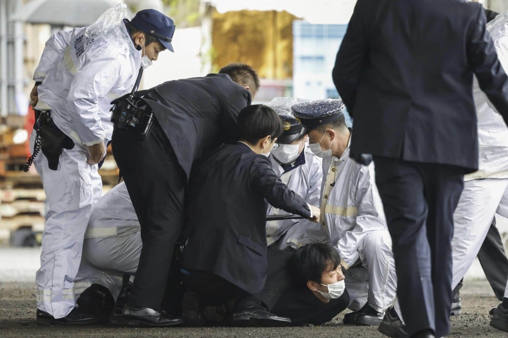 A man is arrested after he allegedly threw an explosive device at Japanese Prime Minister Fumio Kishida at Saikazaki port in Wakayama, western Japan, last year. Photo: Kyodo News via AP