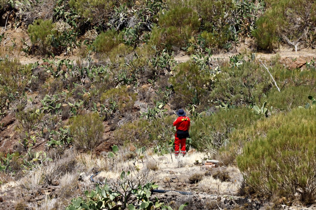 A volunteer firefighter searches for the young Briton Jay Slater in the Juan Lopez ravine near Masca, on the island of Tenerife. Photo: Reuters