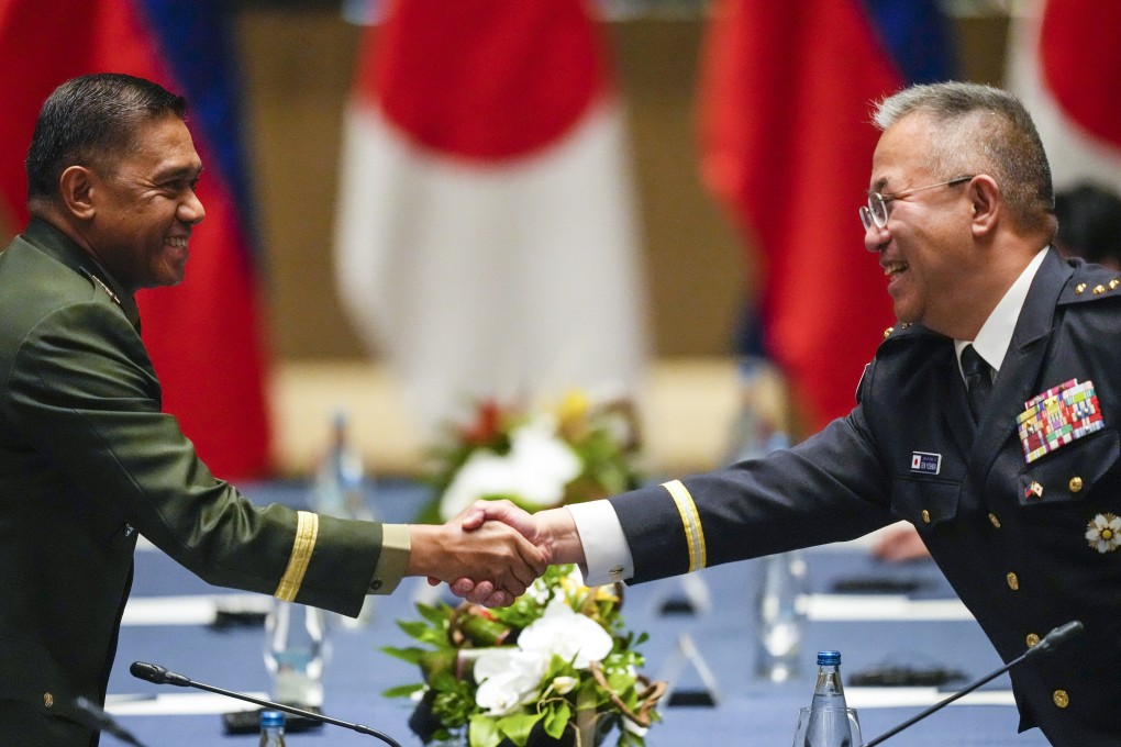 The Philippine and Japanese military chiefs, General Romeo Brawner Jnr (left) and Yoshihide Yoshida, shake hands during a meeting in Taguig, Philippines, on July 8. Photo: AP