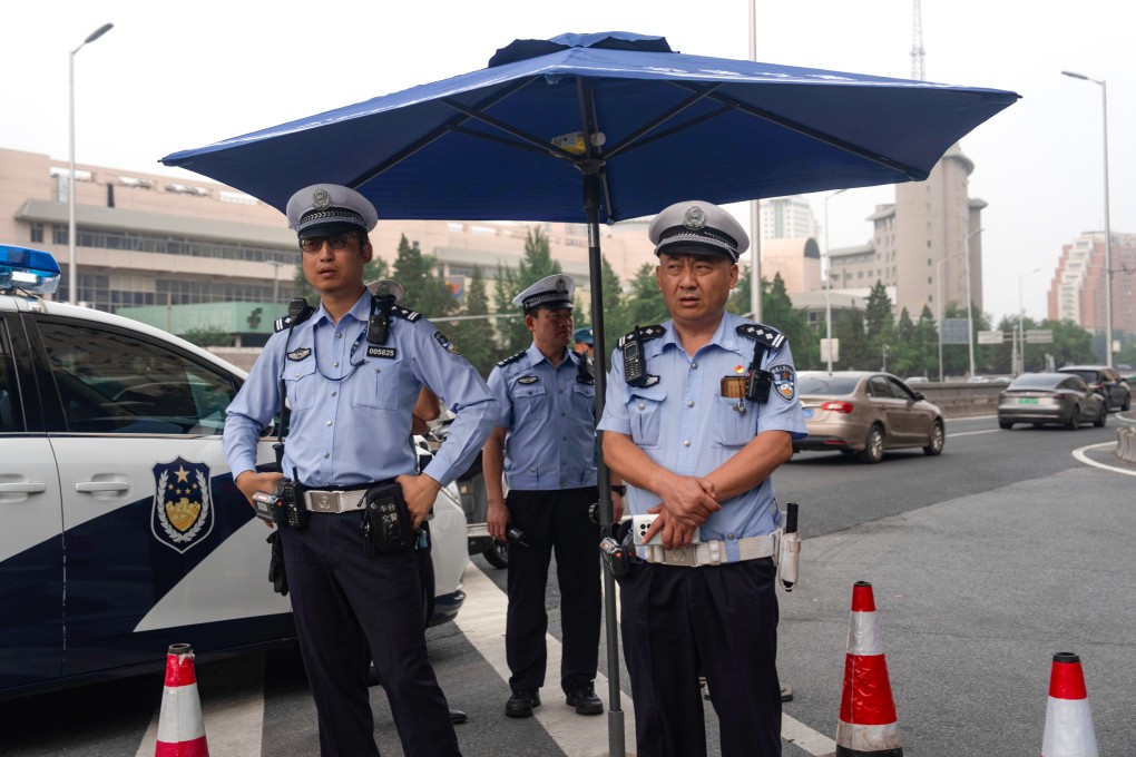 Traffic police officers monitor a road leading towards the Jingxi Hotel where the Communist Party’s Central Committee is holding its third plenum in Beijing, China, on Monday, July 15, 2024. Photo: AP