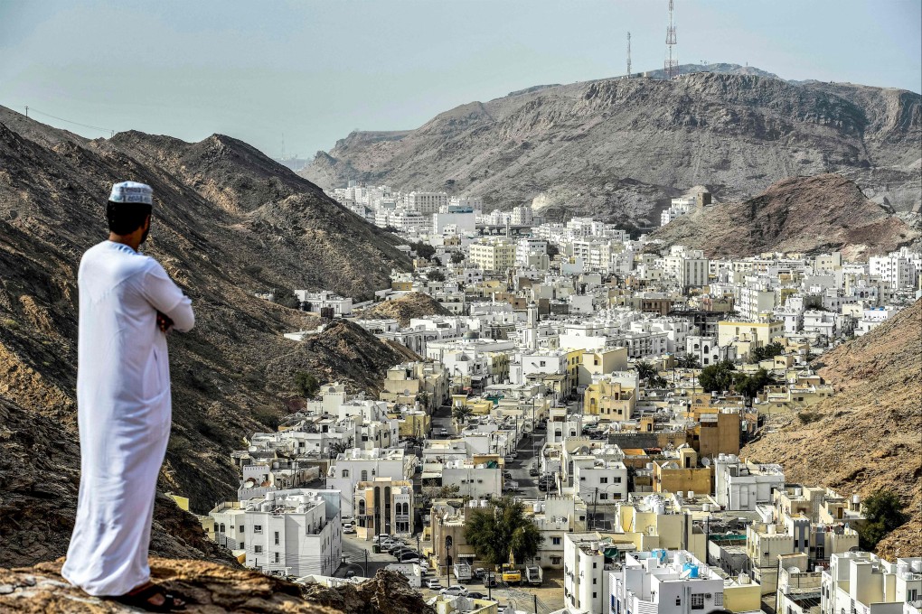 A man stands atop a hill in al-Wadi al-Kabir, where four people died a gunfire attack at a mosque. Photo: AFP