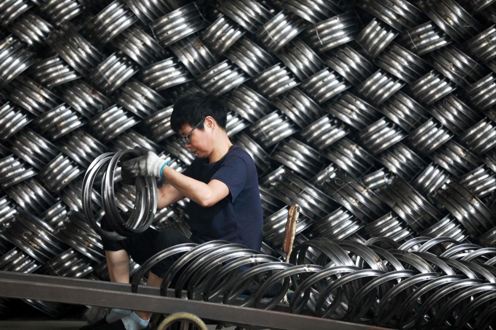 A worker sorts wheels at a factory which produces bicycle parts for export in Hangzhou, in Chinaís eastern Zhejiang province on July 15, 2024. Barclays cut their China GDP forecast for 2024 to 4.8 per cent from 5 per cent, Goldman Sachs reduced it to 4.9 per cent and JPMorgan lowered theirs to 4.7 per cent. Photo: AFP