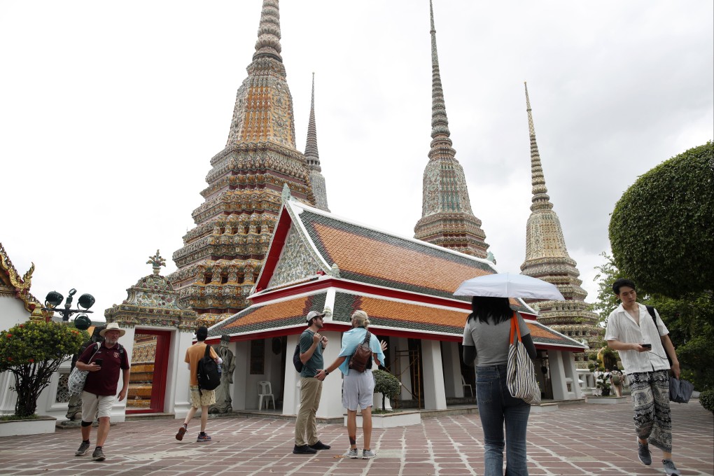 Tourists at Wat Pho temple, also known as the Temple of the Reclining Buddha, in Bangkok. The country has extended visa-free trips for Hongkongers. Photo: EPA-EFE