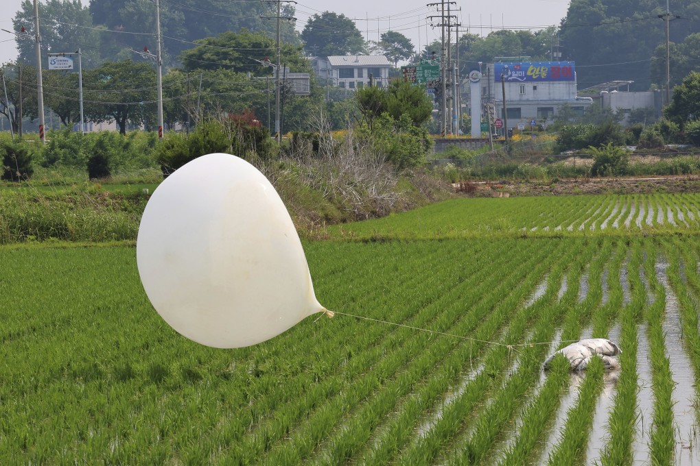 A balloon, presumably sent by North Korea, is seen in a paddy field in South Korea. Seoul says North Korea has launched balloons likely carrying trash toward South Korea on July 18. Photo: AP