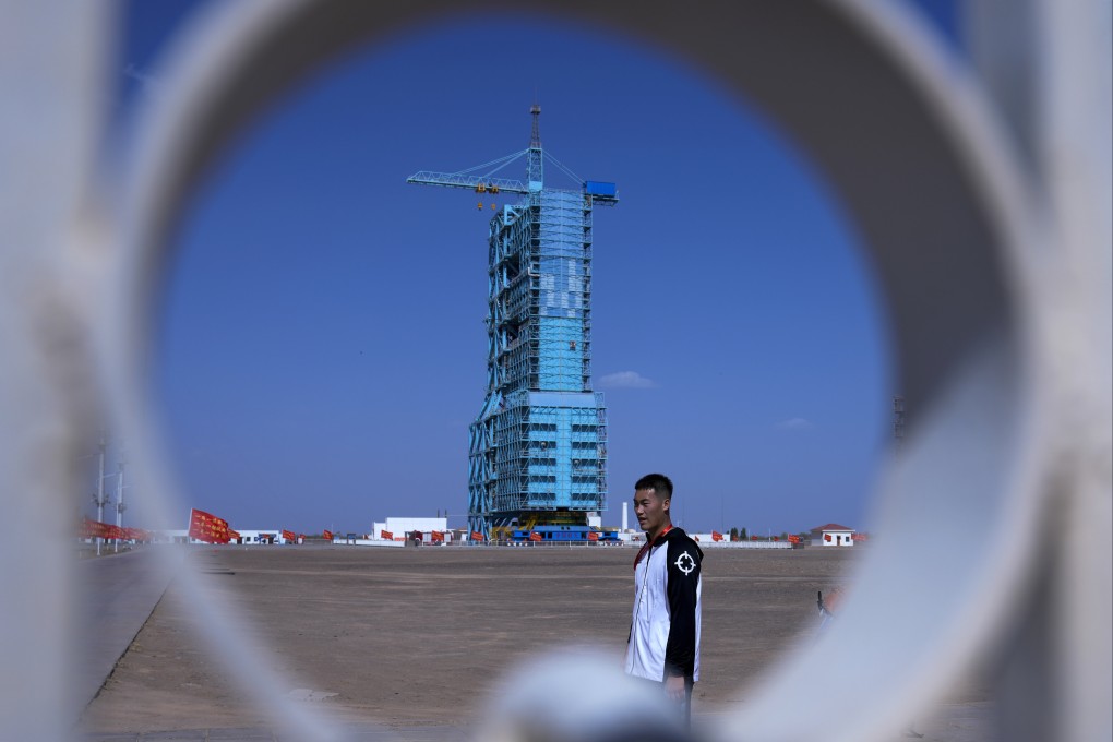 A Chinese soldier walks by the Shenzhou-18 spacecraft sitting atop a Long March rocket covered on a launch pad at the Jiuquan Satellite Launch Centre in northwest China on April 24, 2024. Photo: AP