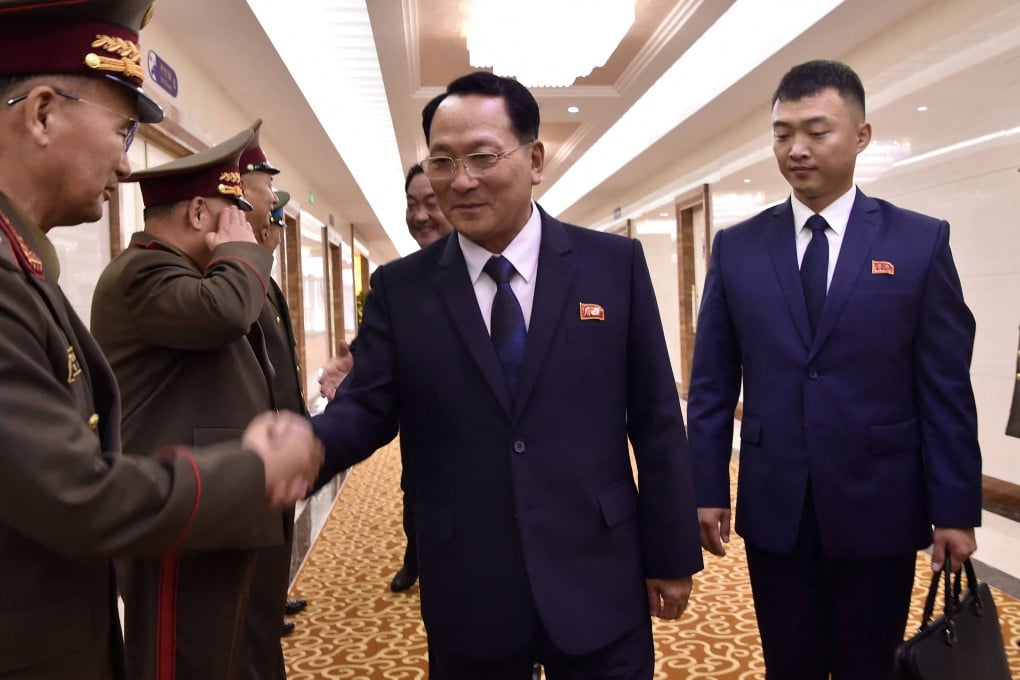 Kim Geum-chol, president of Kim Il-sung Military University, shakes hands with North Korean military officials before departing to Russia from Pyongyang on July 8. Photo: AFP