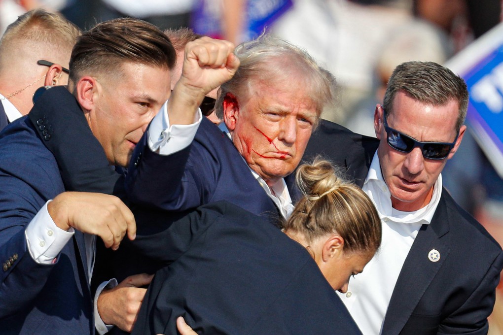 Former US president Donald Trump is rushed off stage by secret service after being grazed by a bullet in Butler, Pennsylvania. Photo: EPA-EFE