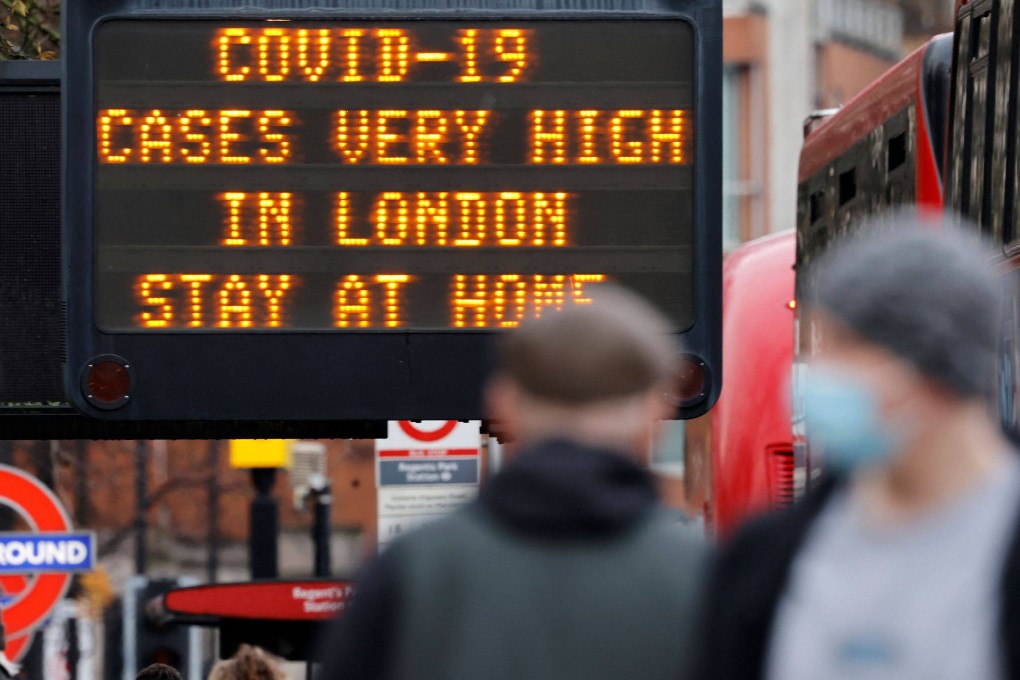 A sign alerts pedestrians that Covid-19 cases are very high in central London in December 2020. Photo: AFP