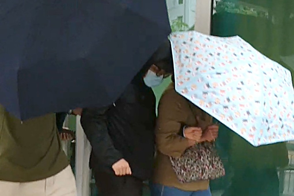 Defendant Chan Pak-yui (masked) is escorted by supporters as he leaves Kowloon City Court on Friday. Photo: Handout