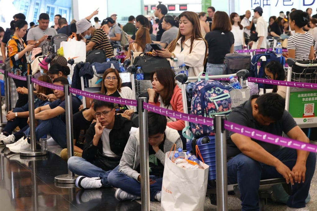 Passengers wait to be checked in at the airport. Photo: Dickson Lee