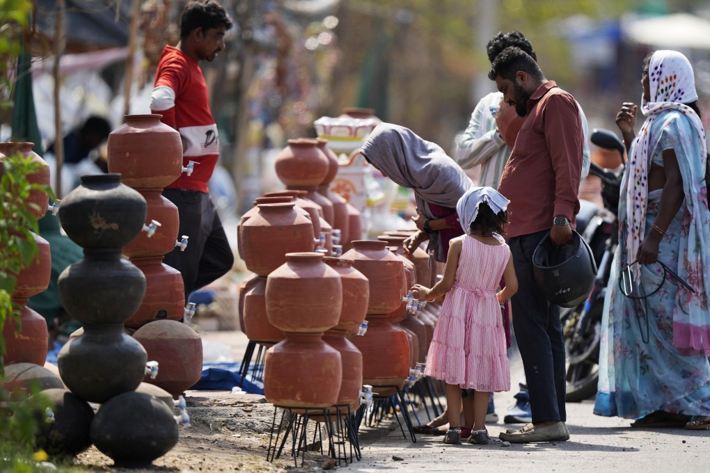 People shop for earthen water vessels, known locally as poor man’s refrigerator, from a roadside vendor in Hyderabad, India, in May. Photo: AP