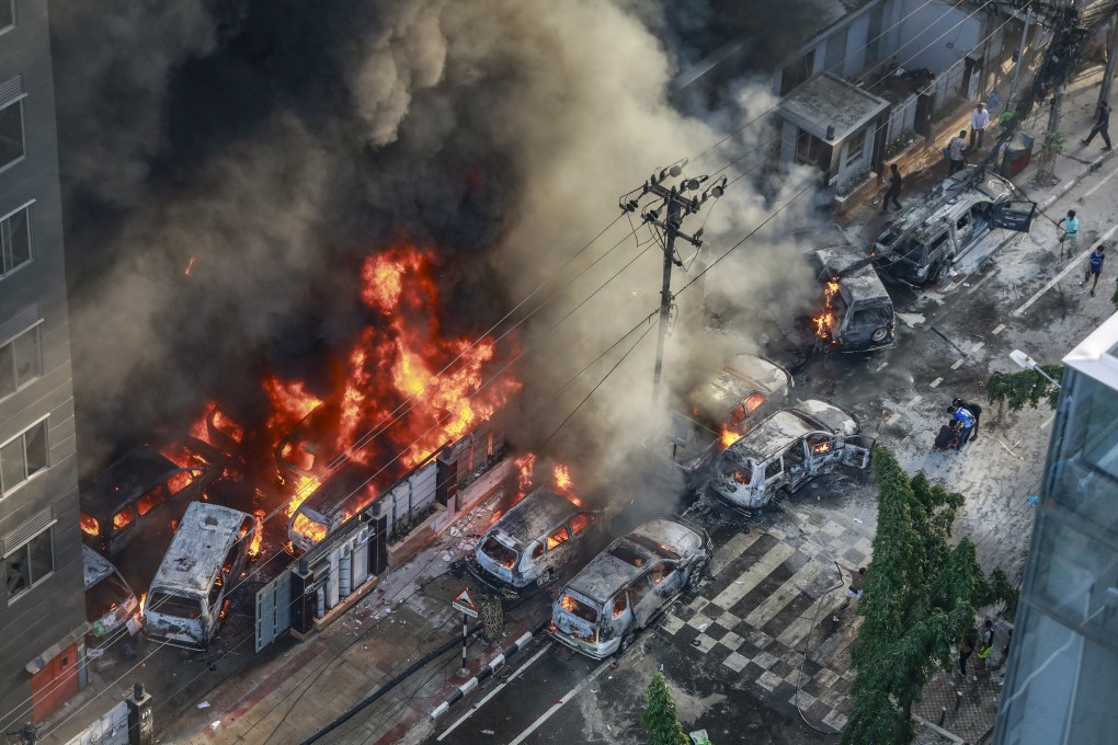 Smoke rises from burning vehicles in Dhaka after Bangladeshi protesters set them on fire near an office on July 18. Photo: TNS