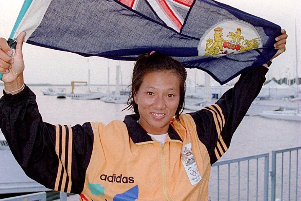 Lee Lai-shan holds up the Hong Kong flag after winning the territory’s first Olympic medal, a sailing gold, at the 1996 Atlanta Games.