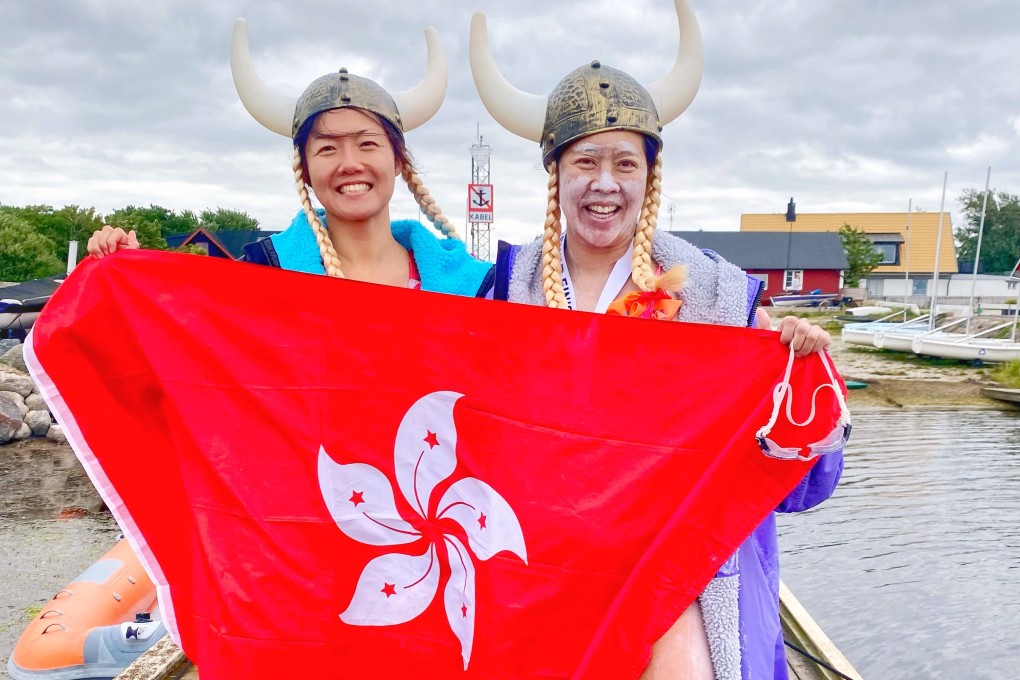 Edie Hu (right) holds the Hong Kong flag after completing the Oresund Strait swim in record time. Photo: Amy Miao