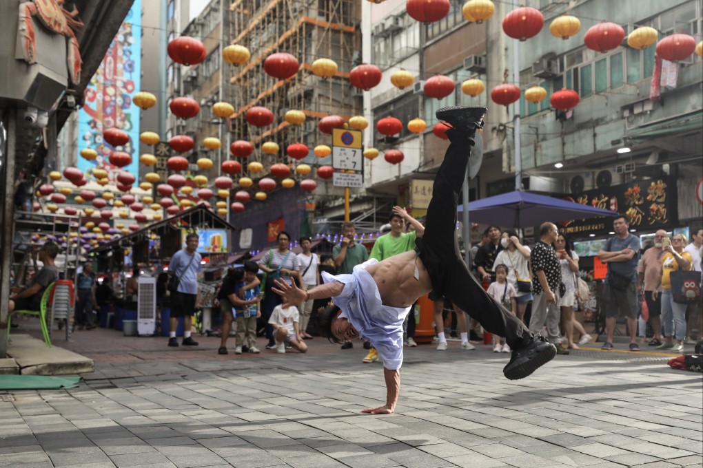 Shenzhen dancer and influencer Yan Zhangbian pops spectacular break dance moves in Hong Kong’s Temple Street as part of a joint effort to boost tourism. Photo: Xiaomei Chen