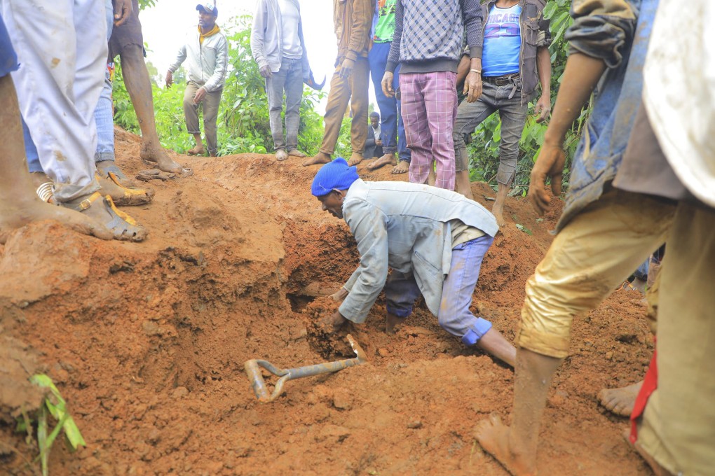 A man searches for survivors hundreds of people gather at the site of a mudslide in southern Ethiopia on Monday. Photo: AP