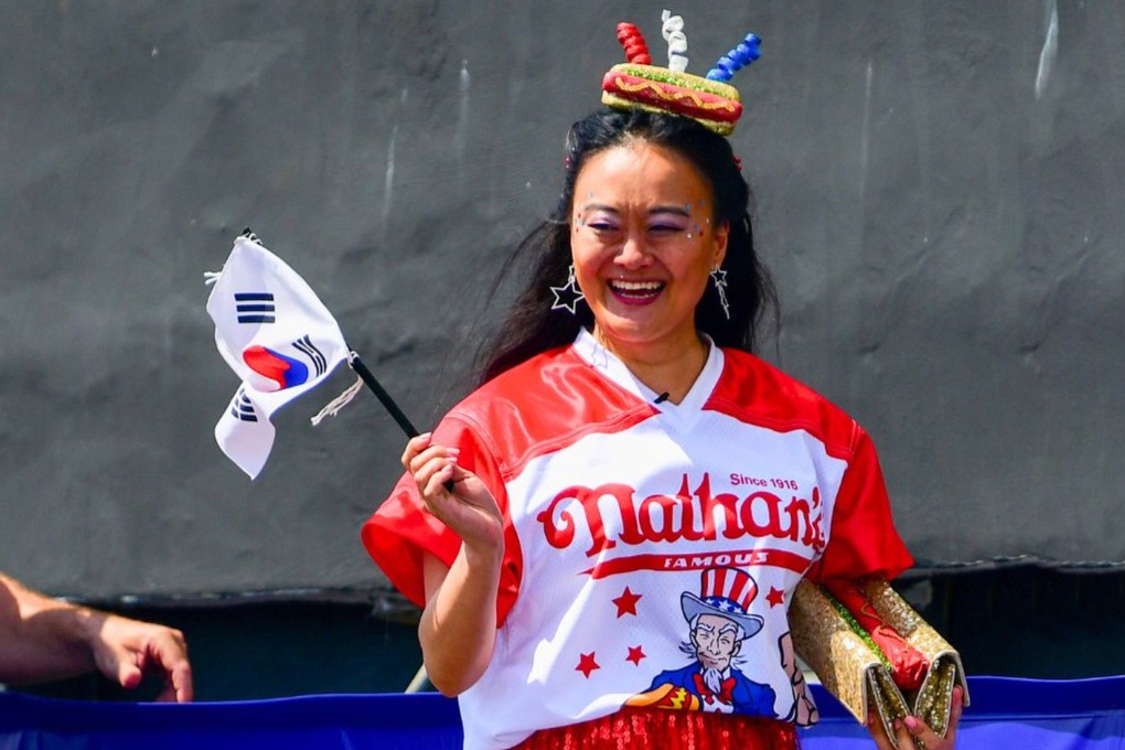 Korean Mary Bowers at the Nathan’s Famous Hot Dog Eating Contest in New York in July 2024. The competitive eater is on a mission to discover the truth about her adoption from Korea, having found her brother, also adopted, through DNA testing. Photo: X/@EatBeMary