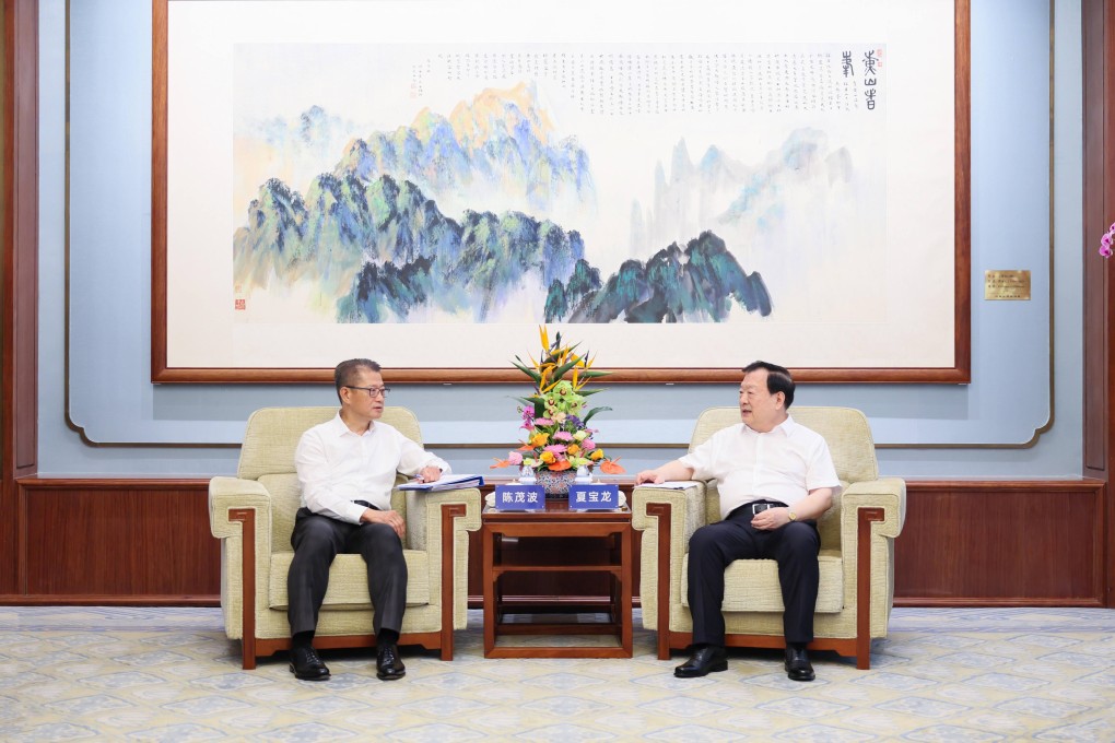 Xia Baolong (right) met Financial Secretary Paul Chan on Tuesday in Beijing after the end of the third plenary session for the party’s 20th Central Committee last week.