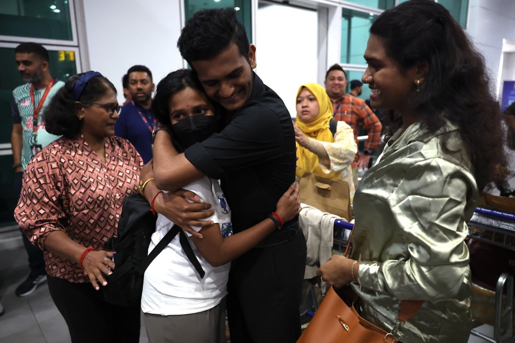 A student, who was among the Malaysians evacuated from Bangladesh on Tuesday, is greeted by a family member at Kuala Lumpur airport. Photo: EPA-EFE