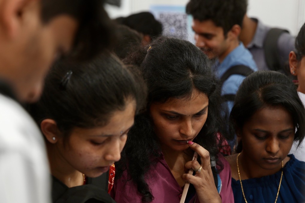 Job seekers get information at a job fair organised by Karnataka state government in Bangalore, India on February 27. Photo: EPA-EFE