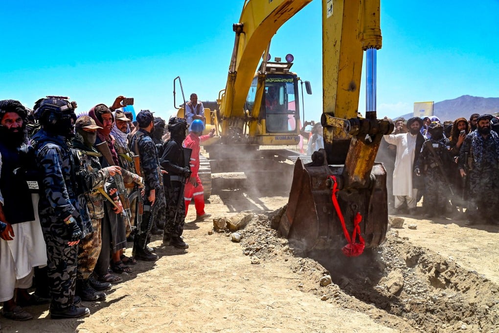 Taliban security personnel surround an excavator during the inauguration ceremony. Photo: AFP