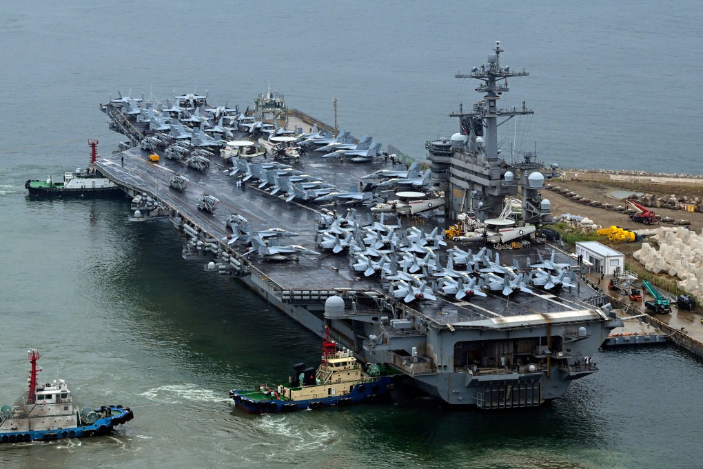 The Theodore Roosevelt (CVN 71), an American nuclear-powered aircraft carrier is anchored in Busan. Three Chinese accused of illegally photographing the ship say they were curious. Photo: AP