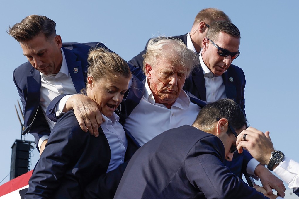 Republican presidential candidate Donald Trump is rushed offstage by United States Secret Service agents after being grazed by a bullet during a failed assassination attempt in Butler, Pennsylvania, on July 13, 2024. Photo: Anna Moneymaker/Getty Images/TNS