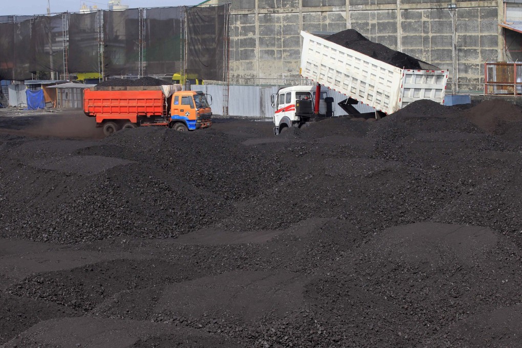 A truck unloads coal in Tondo, Manila. Investments in fossil fuels and other climate-related industries could pose significant risks to banks and insurers in the event of an abrupt transition to meet climate change goals. Photo: Reuters