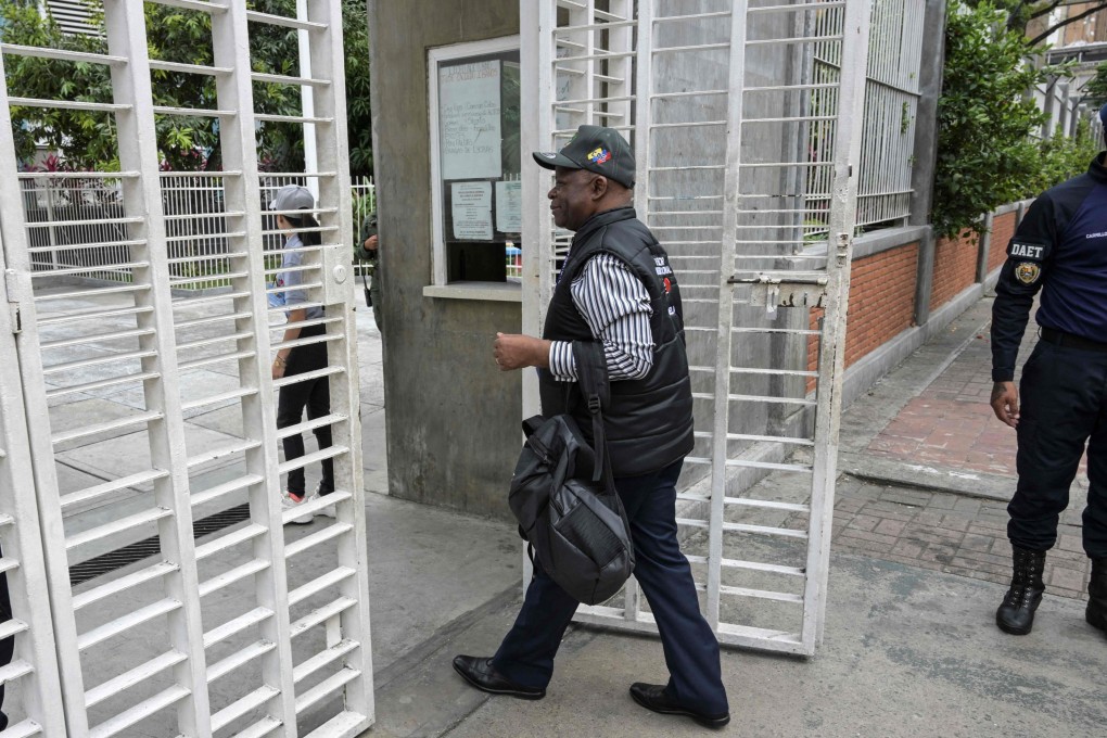 Members of the international delegation of electoral observers visit one of the main voting centres in the upcoming presidential election, in Caracas, Venezuela on July 26. Caracas was accused of blocking international observers from arriving for Sunday’s vote. Photo: AFP