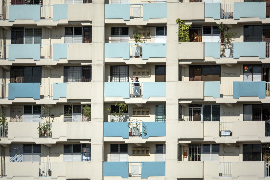 People walk along an external corridor at a Housing & Development Board (HDB) public housing estate in the Toa Payoh district of Singapore in April 2019. Photo: Bloomberg