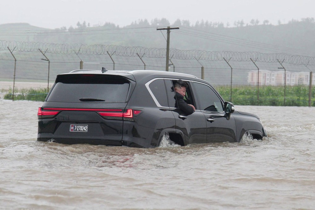 North Korea’s leader Kim Jong-un inspects flood damage from a car in the city of Sinuiju, North Pyongan province. Photo: AFP/KCNA via KNS