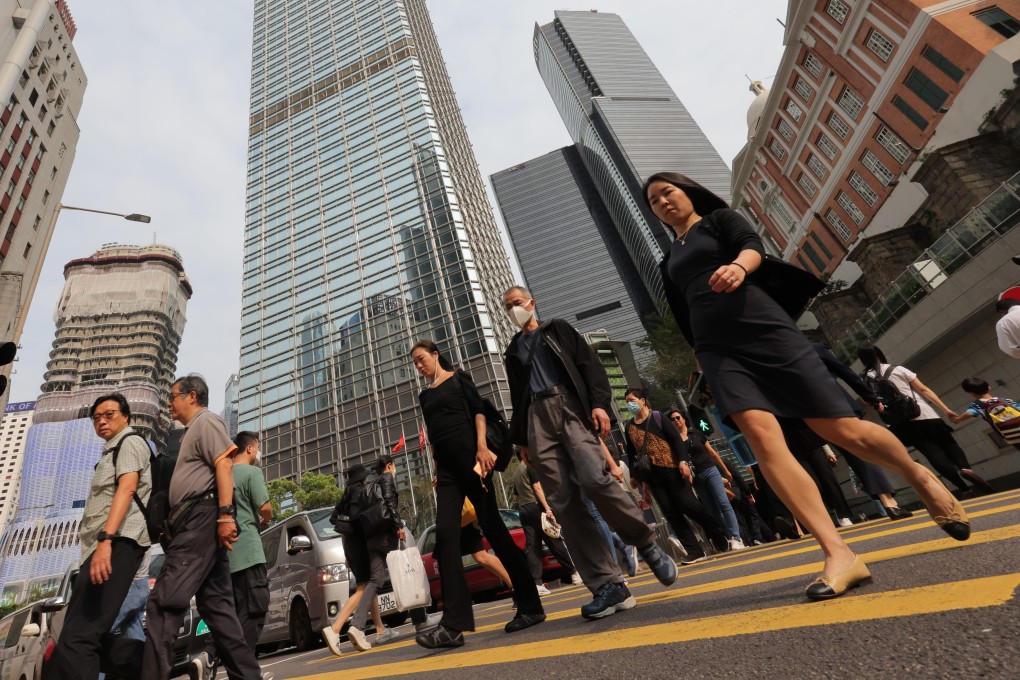 People cross the road in Hong Kong’s Central district. Record amounts of vacant office space are driving firms to seek upgrades in their real estate, bolstering leasing activity and offering bright spots in Hong Kong’s property sector. Photo: Jelly Tse