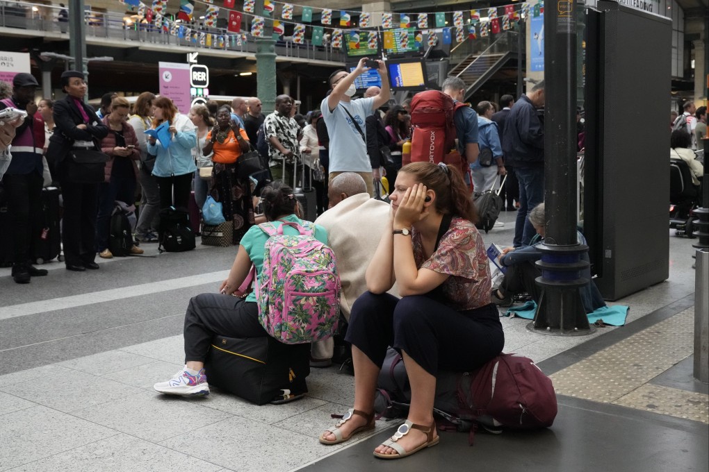 Travellers waits inside the Gare du Nord train station as high-speed rail traffic to the French capital was severely disrupted before the start of the 2024 Summer Olympics on Friday. Photo: AP