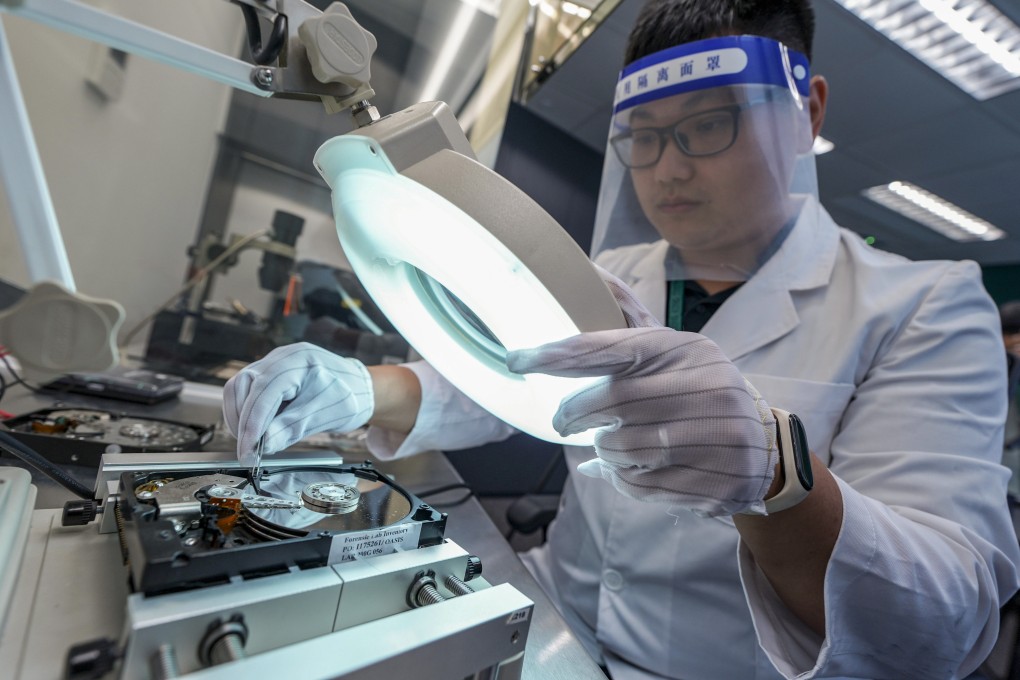 A lab technician demonstrates a hard disk drive inspection at customs’ computer forensic lab in North Point. Photo: Eugene Lee