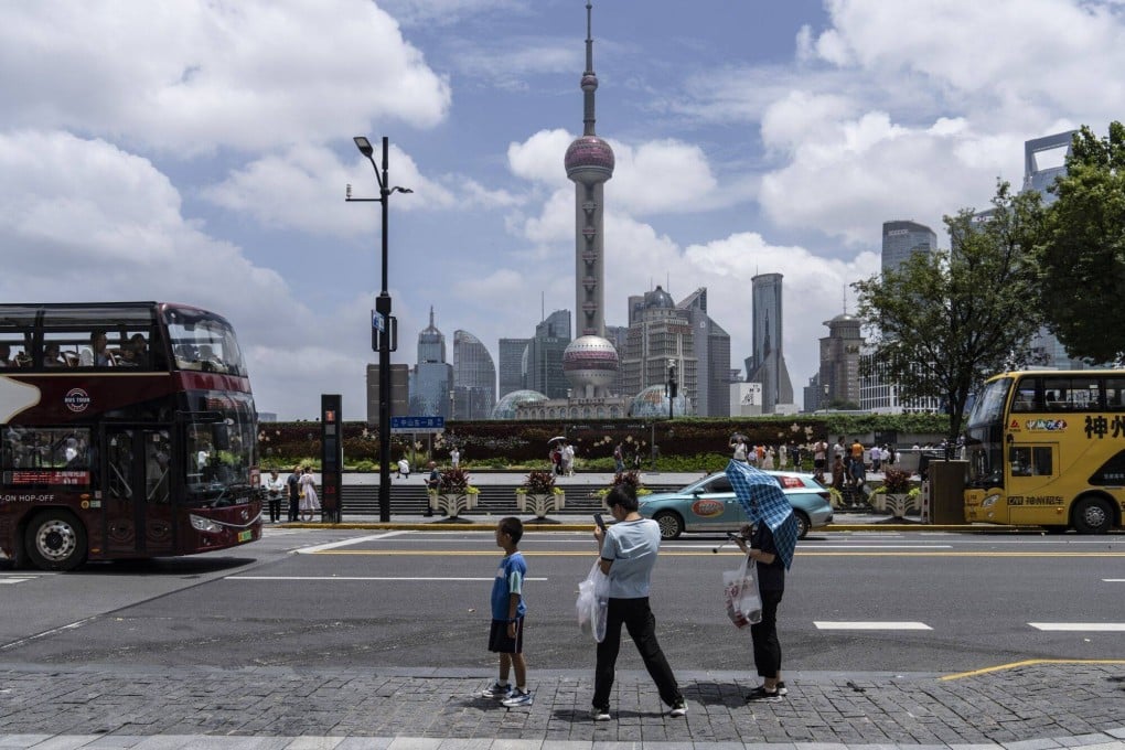 Pedestrians walk on the Bund in Shanghai. Photo: Bloomberg